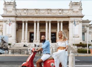 A couple on a scooter in front of the Galleria Nazionale in Rome.